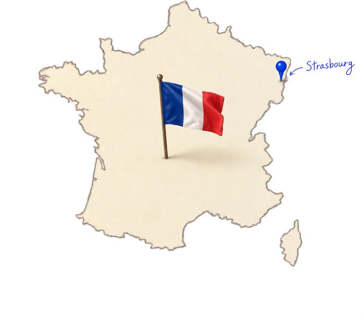 Carte de France en papier découpé avec un drapeau tricolore et une épingle bleue sur Strasbourg, annotée à la main